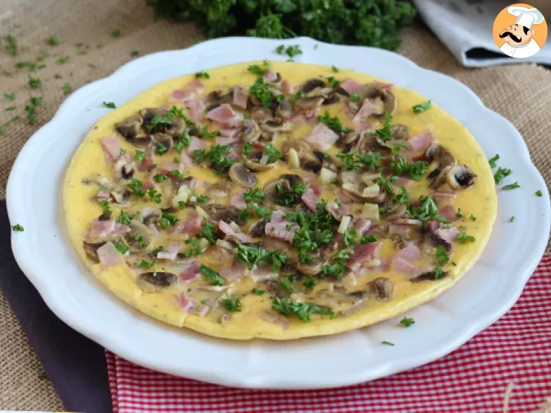 French omelette with mushrooms, ham and parsley