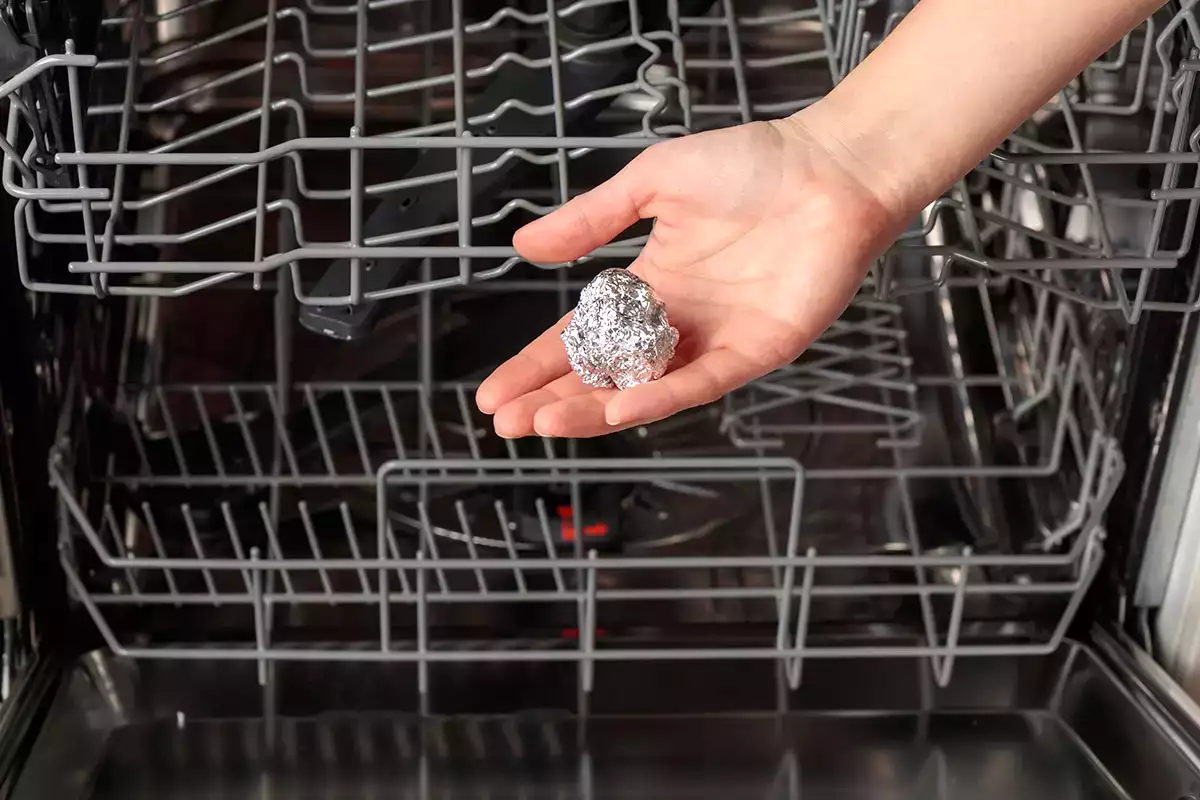 Why experts add an aluminum ball to the dishwasher before each cycle