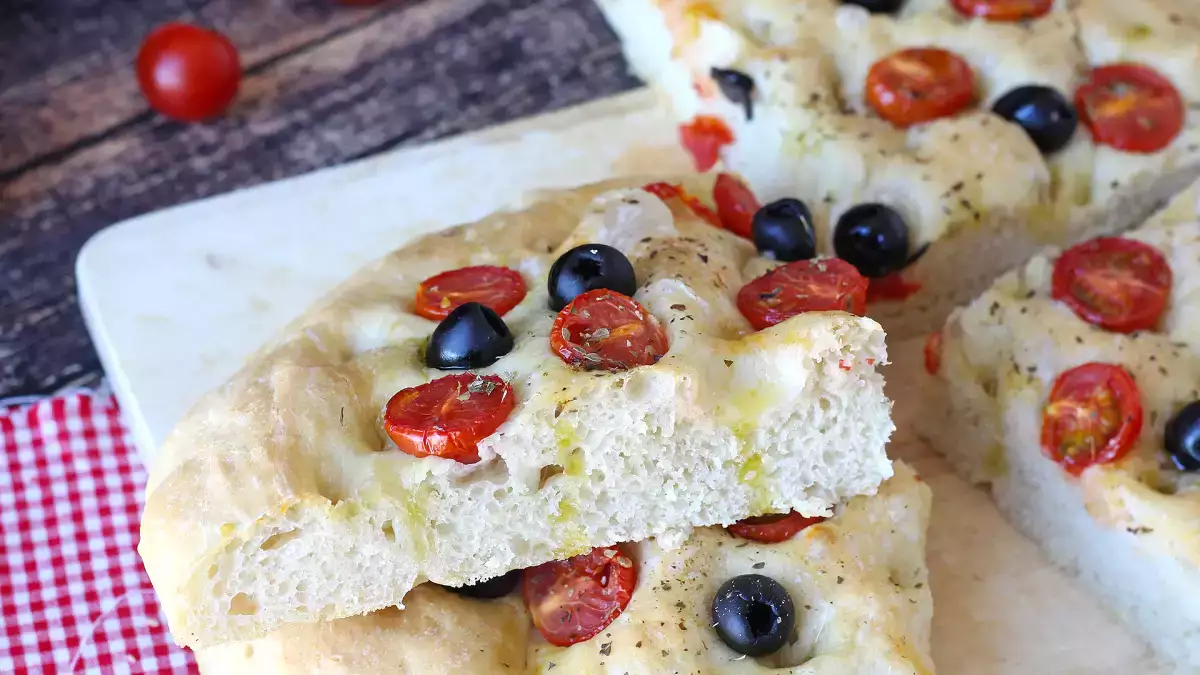 This must-try thick focaccia with cherry tomatoes and olives fills your home with a delicious aroma