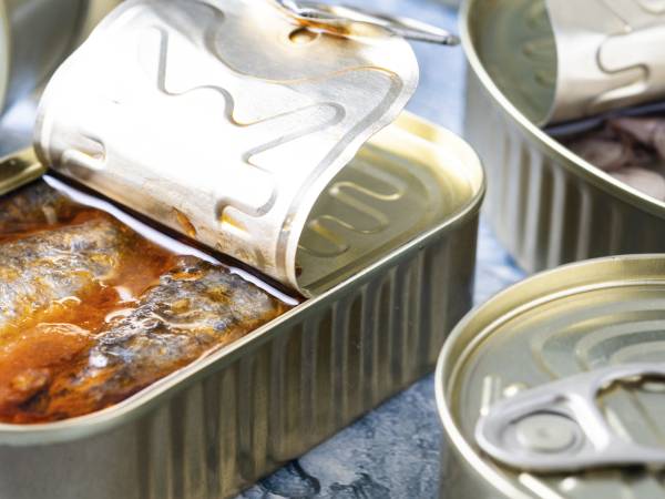 Why should you never keep open cans in the refrigerator?