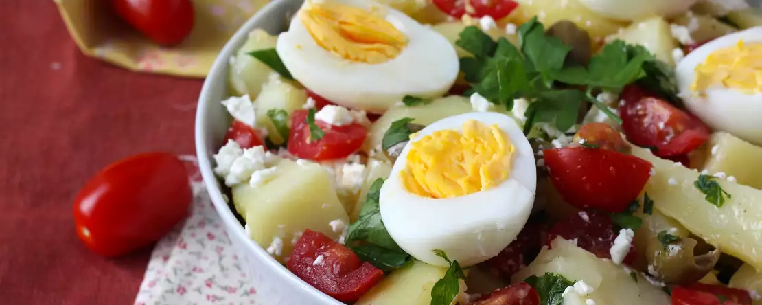 Potato salad with feta cheese, egg, and cherry tomatoes