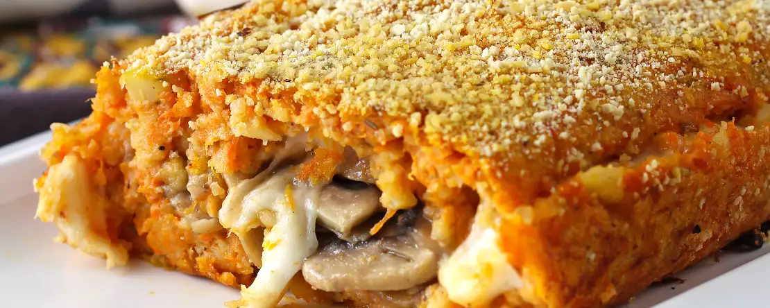 Vegetarian pumpkin meatloaf with mushrooms and stringy scamorza cheese