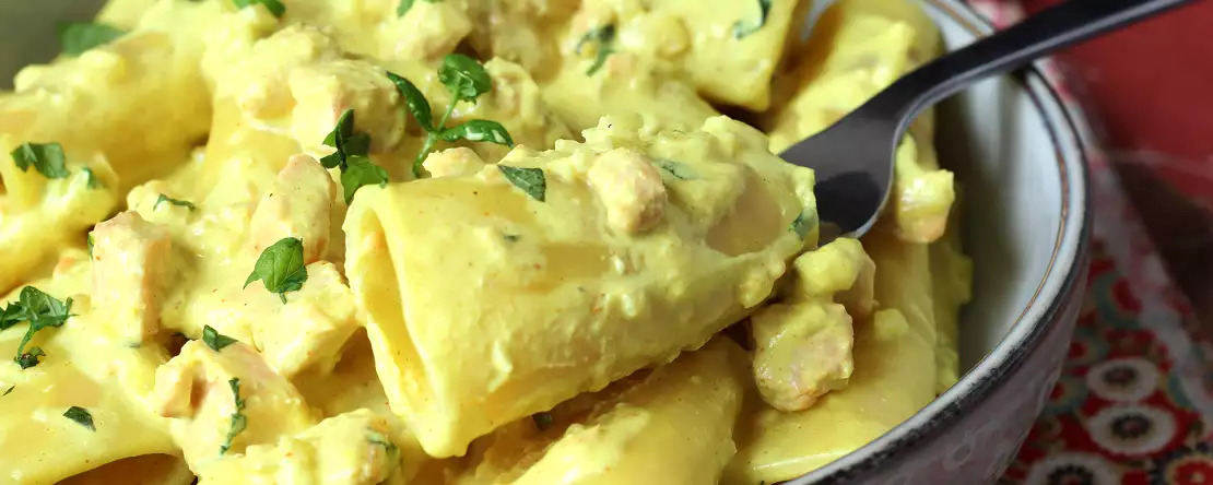 Creamy paccheri pasta with salmon, mint, and saffron