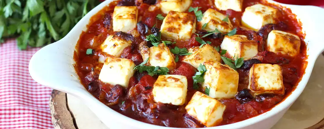 Simmered red beans with tomatoes and roasted feta
