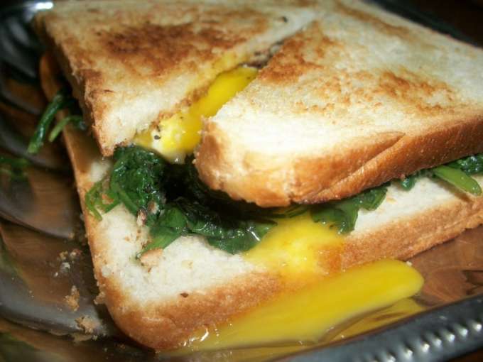 Breakfast sandwich with spinach and fried egg