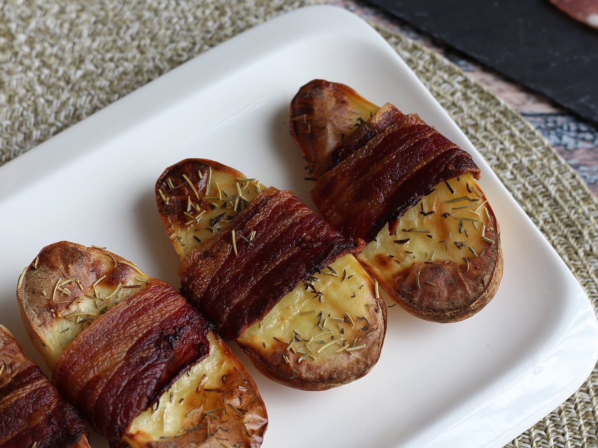 Baked potatoes coated with bacon