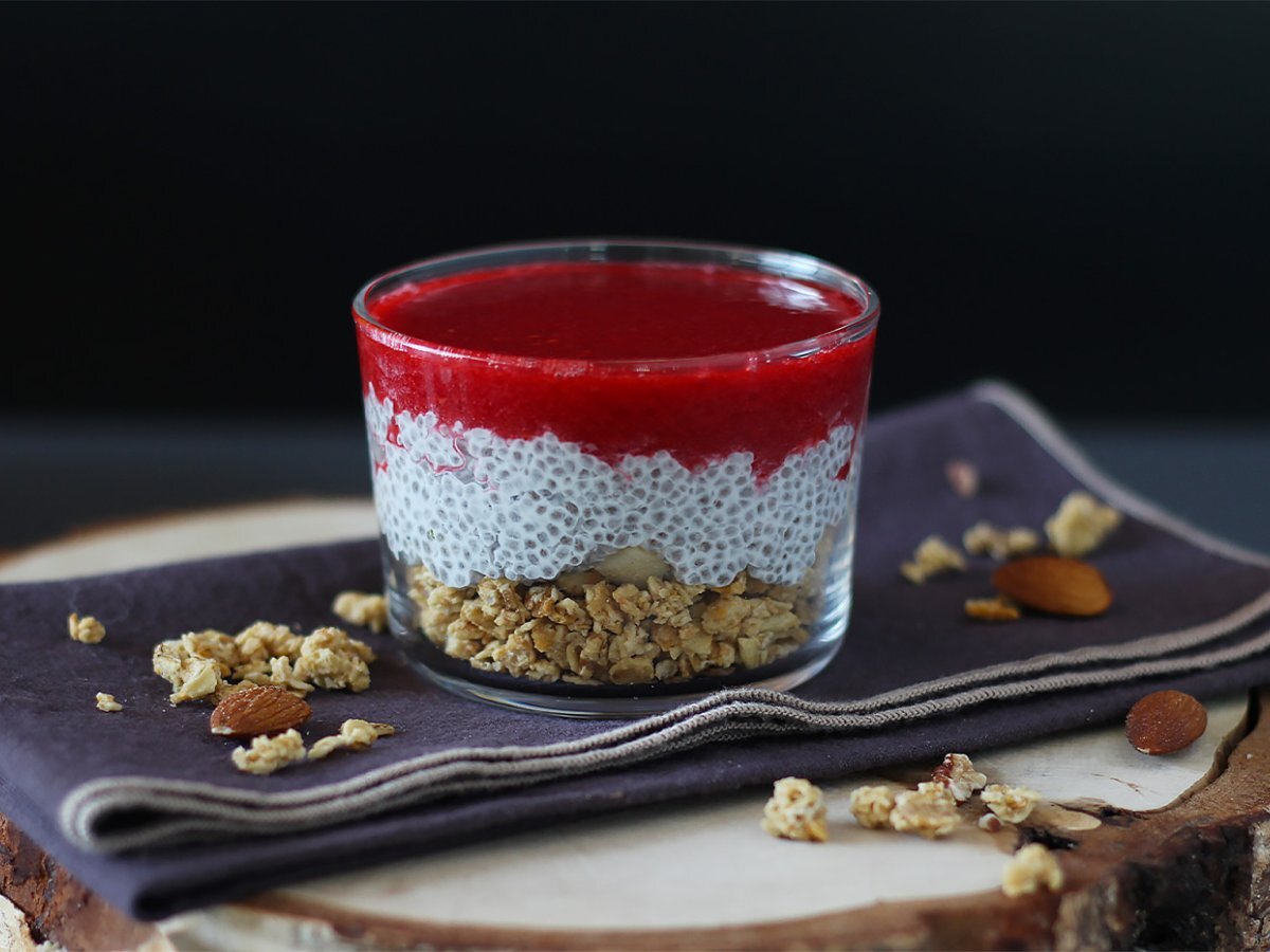 Coconut milk chia pudding verrine with granola and raspberry