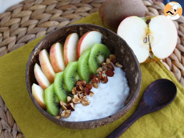 Coconut yogurt snack with apple, kiwi, and hazelnuts