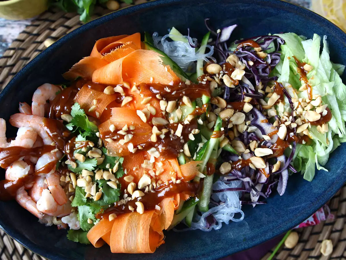 Colourful rice vermicelli and shrimp salad with peanut sauce