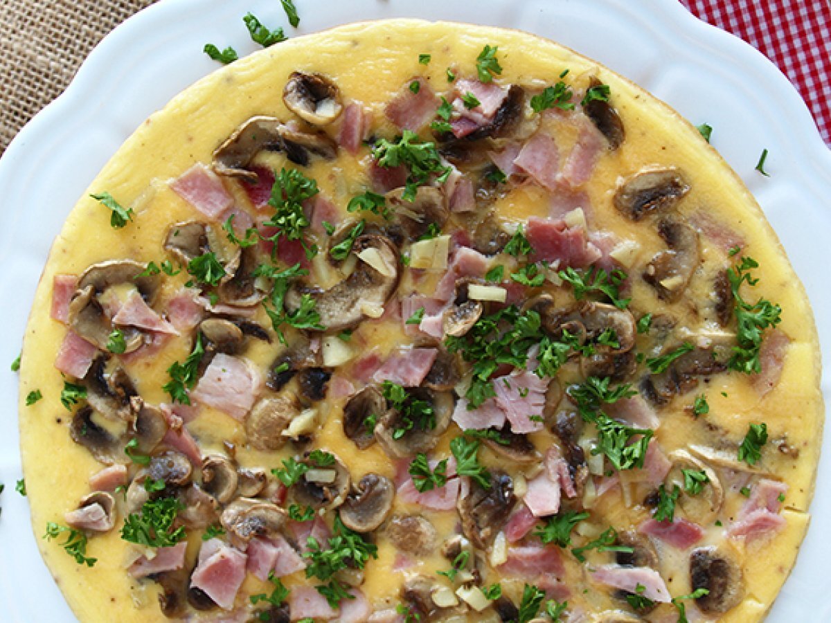 French omelette with mushrooms, ham and parsley - photo 2