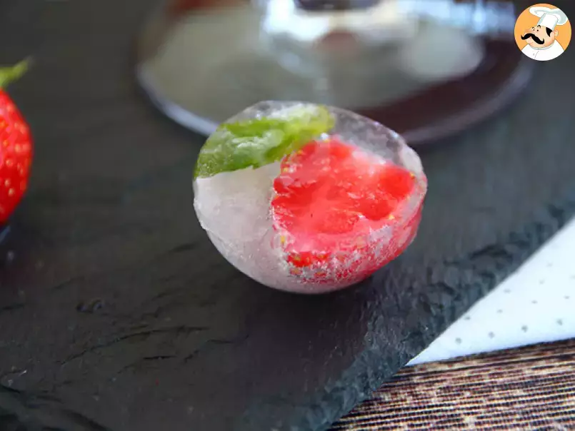 Ice cubes with red berries and mit leaves