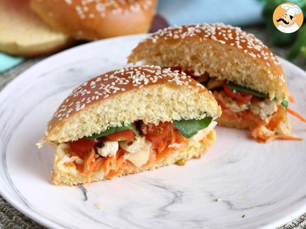 Marinated chicken sandwich with coleslaw, tomatoes, and basil