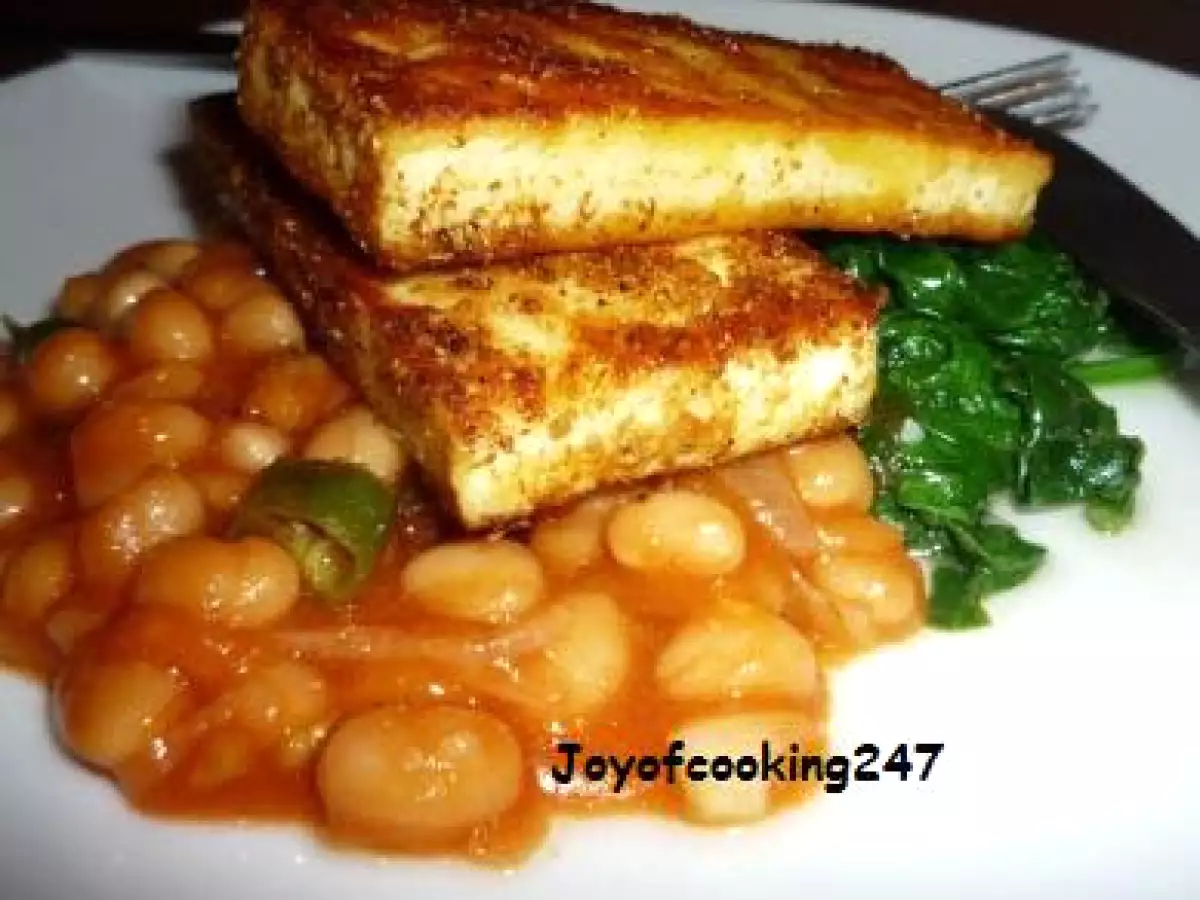 Marinated Tofu-paneer (Indian Cottage Cheese) on a bed of wilted spinach and baked beans