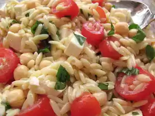 Orzo pasta salad with chickpeas, tomatoes, mozzarella, and basil