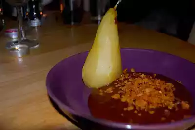 Poached pears in a chocolate and "baileys" custard with a flapjack crumble topping.