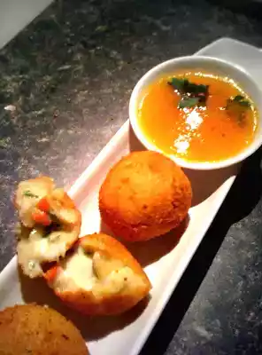 Yuca beignets filled with cheese and Orange spicy sauce